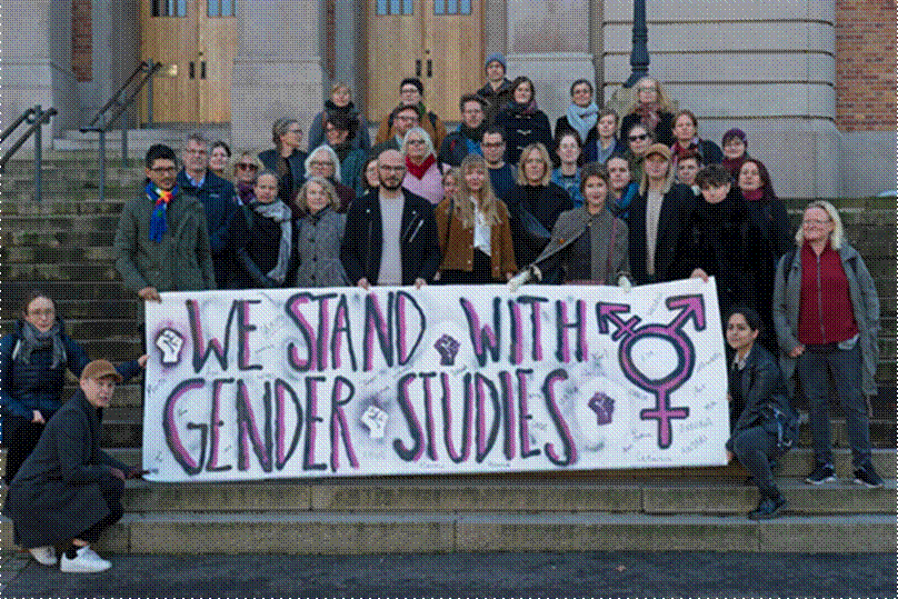 Title: Picture 2: We Stand With Gender Studies - Description: The author with students who made the banner and Staff at the University of Gothenburg 
Source: Photo by Thomas Melin, GU-Journalen