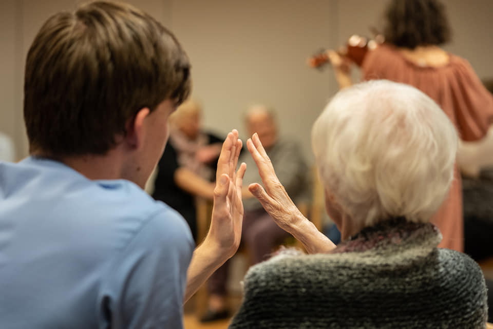 Two persons, two hands meeting.