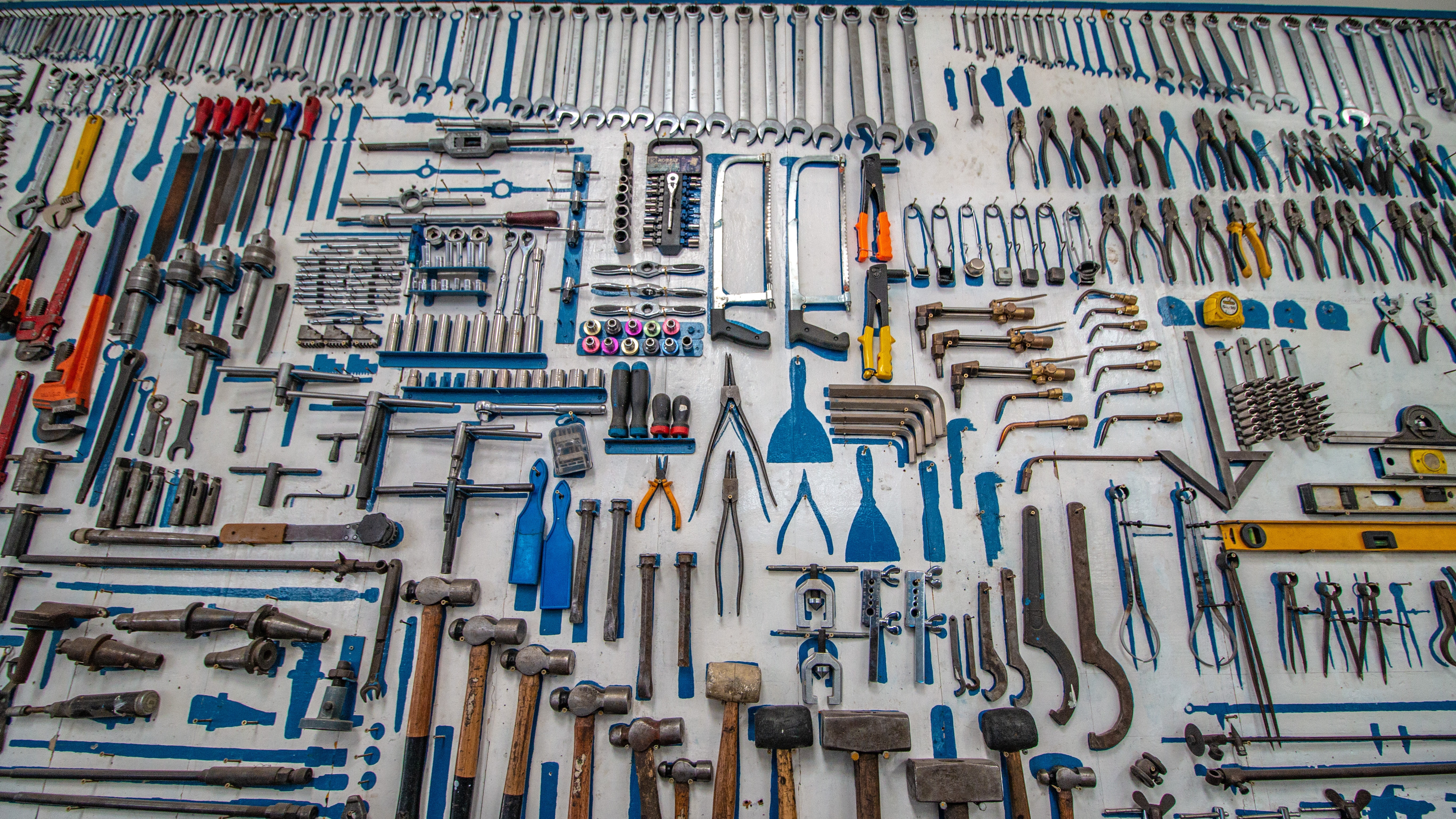 Handheld tools spread out on a table. Photo by Cesar Carlevarino Aragon on Unsplash