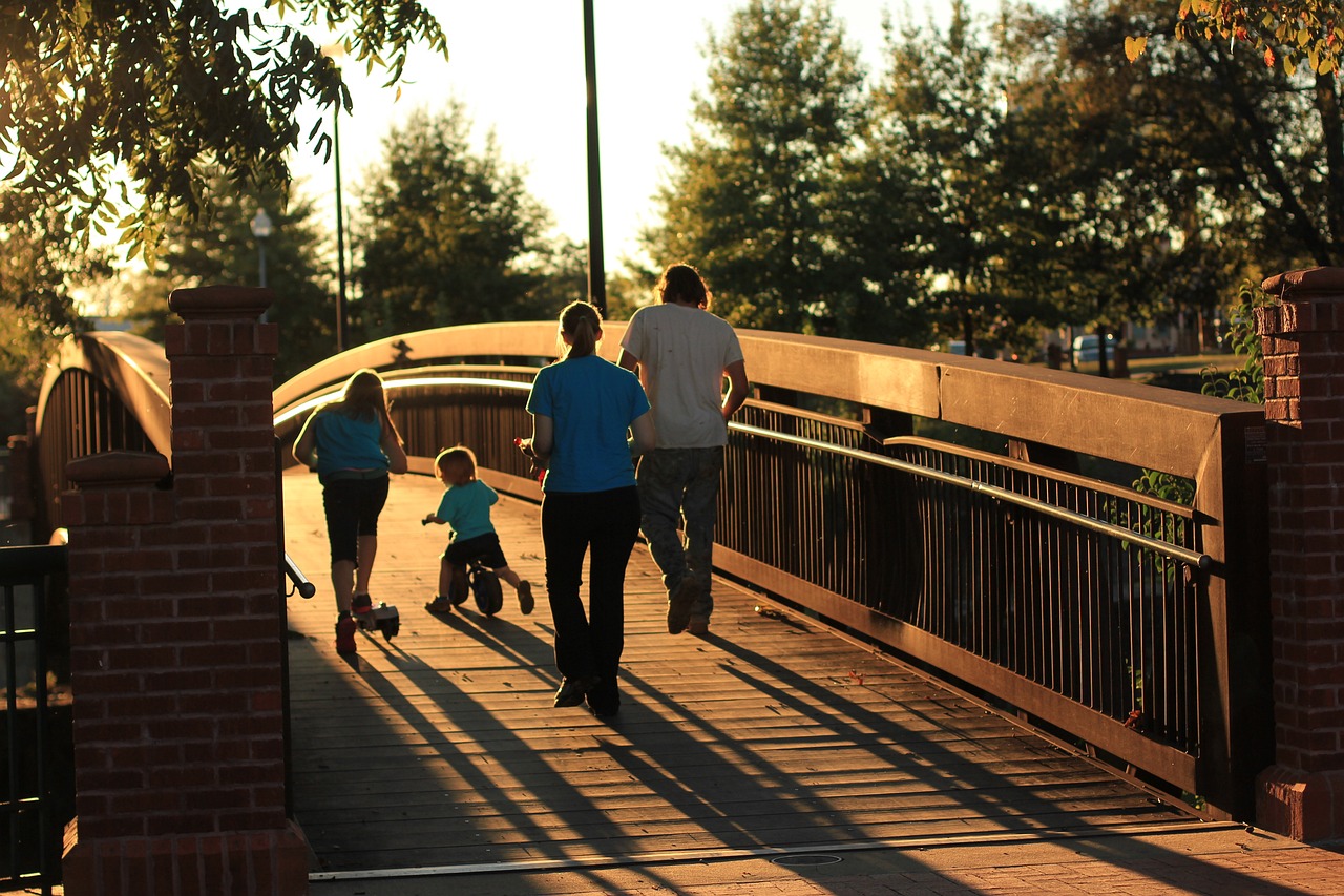 A family walking onto a wodden bridge