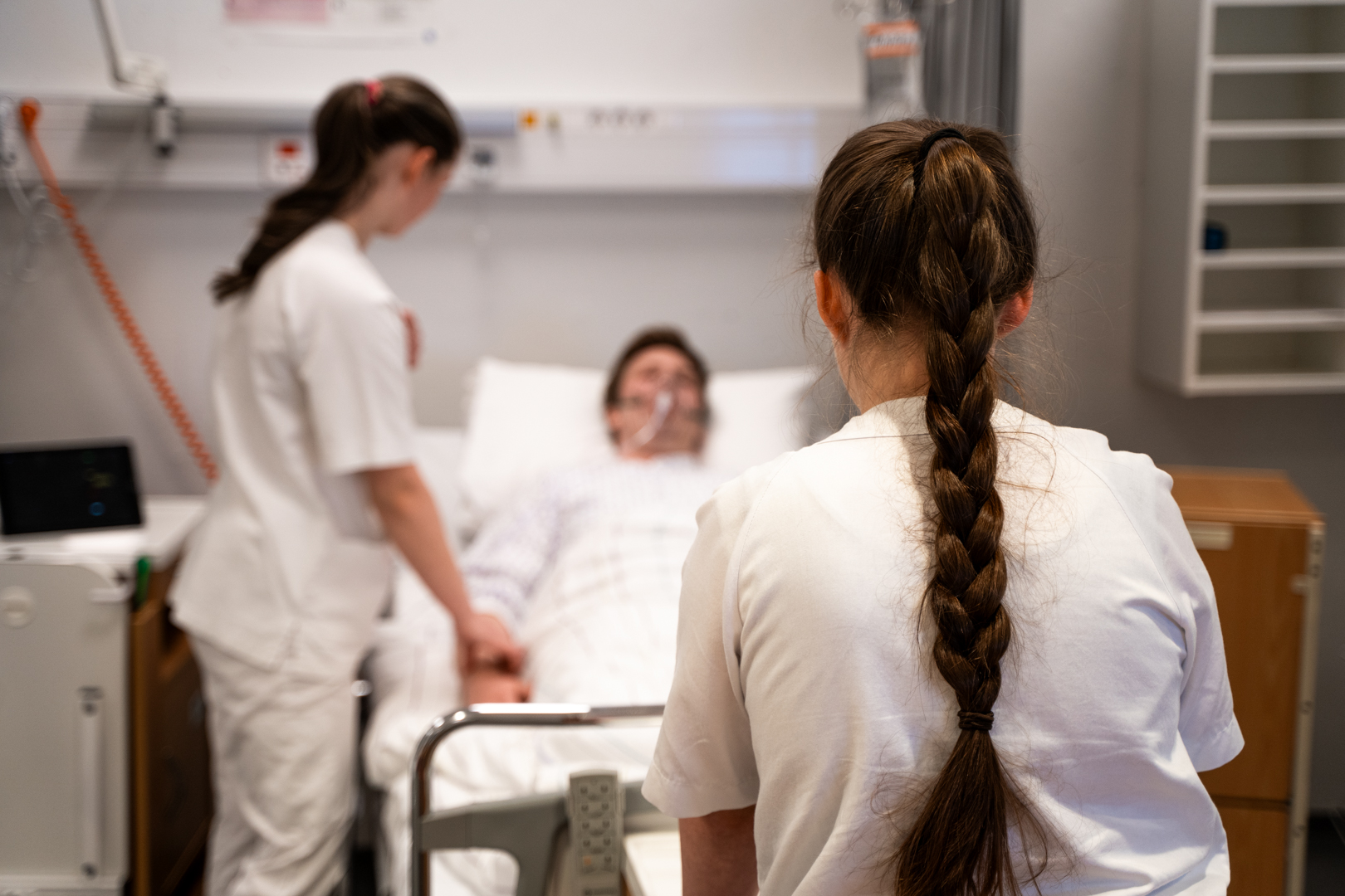 Nursing students at a patient's bedside