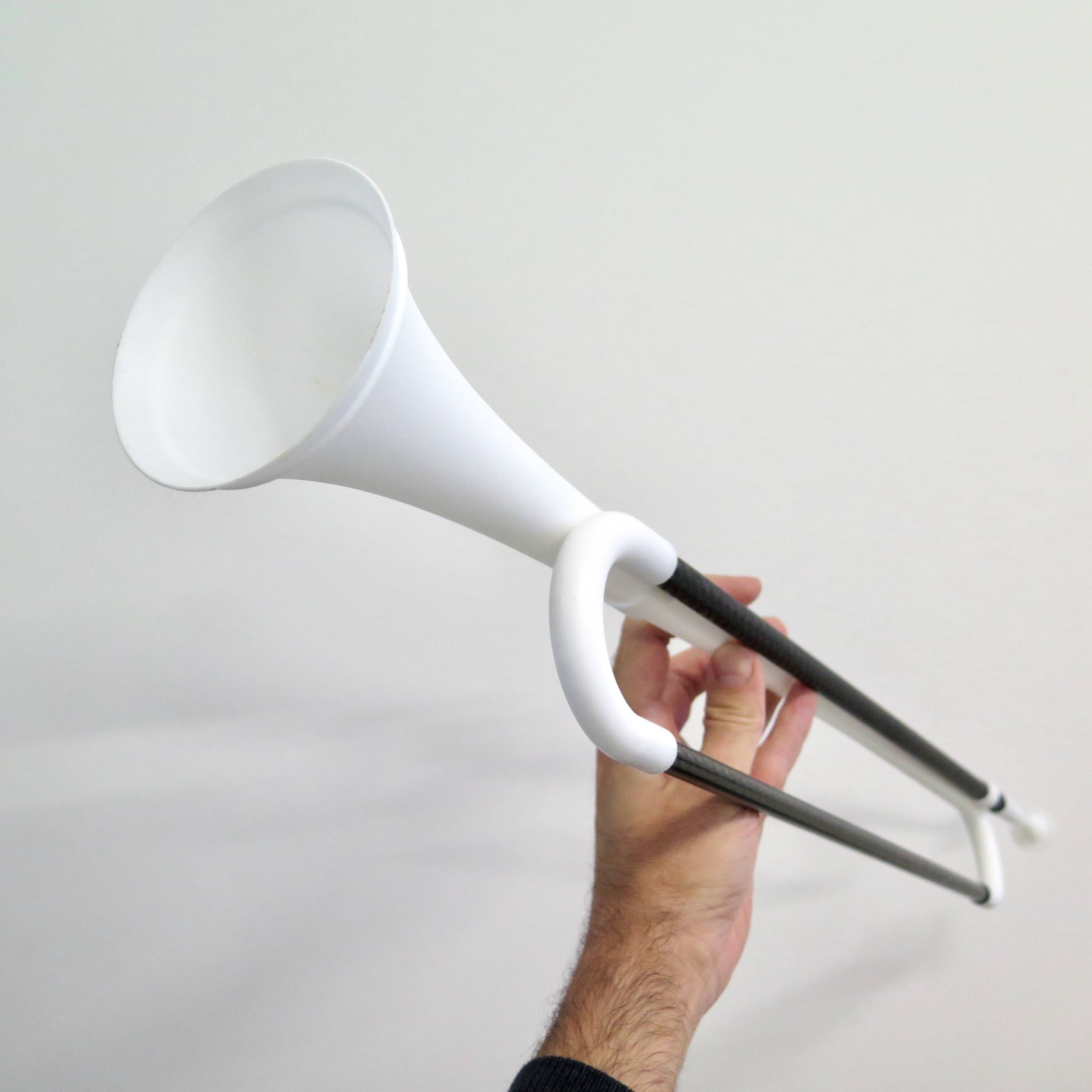 A hand holding a musical instrument made with Additive Manufacturing (AM)
