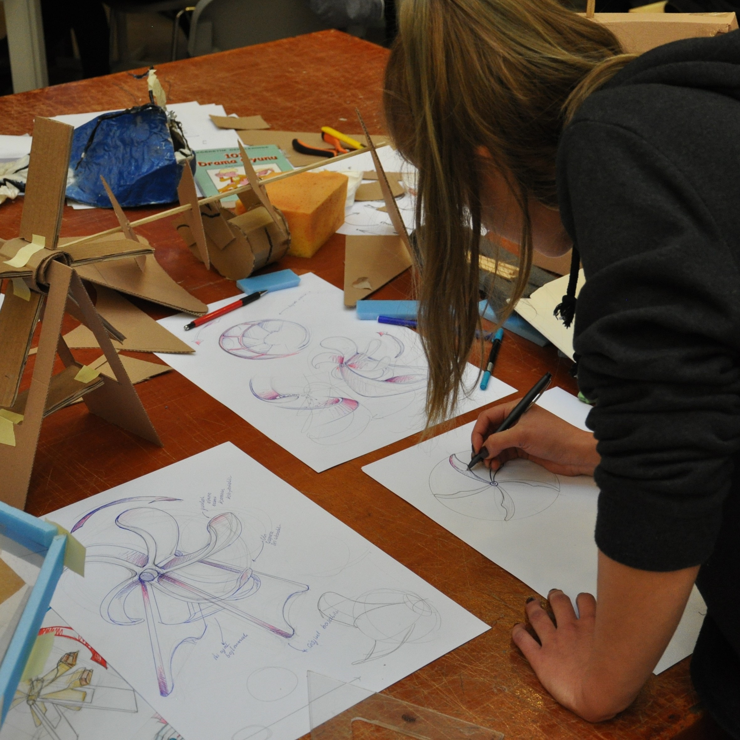  A design student working on sketches and mock-ups in the studio