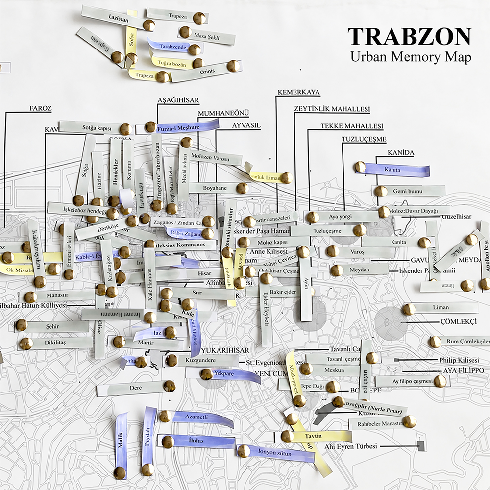 Urban memory map of Trabzon showing the contemporary city map overlaid with locations, neighbourhoods and urban landmarks identified through historical travel narratives. Coloured and rolled paper labels mark spatial references associated with different travellers and periods.